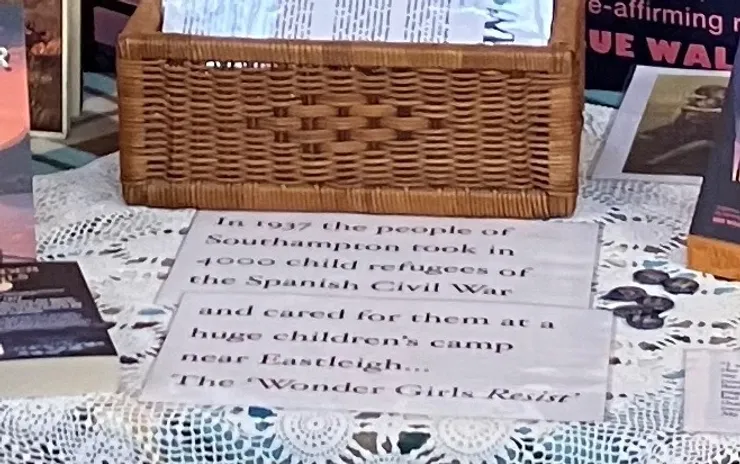 close up of my market stall showing the sign I use to catch readers' attention. The sign reads 'In 1937 the people of Southampton took in 4000 child refugees of the Spanish Civil War and cared for them at a huge children's camp near Eastleigh... 'The Wonder Girls Resist'