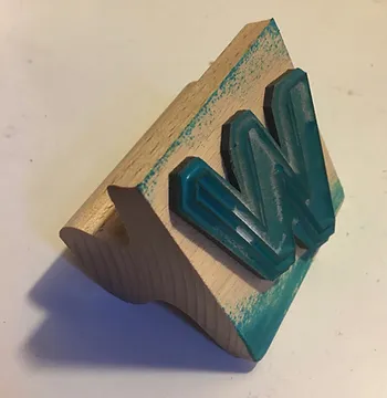 A wooden 'W' stamp
