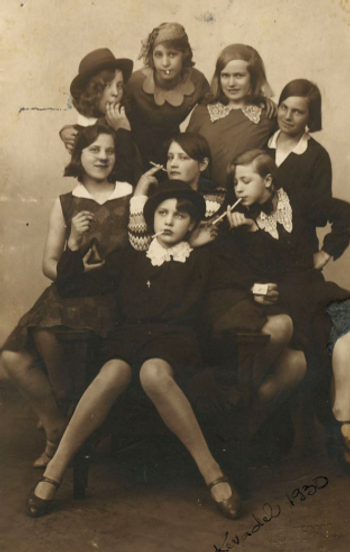 A sepia photo from 1930  of a 'Bugsy Malone' style gang of eight girls