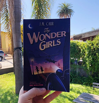 The Wonder Girls paperback against a backdrop of Californian palm trees