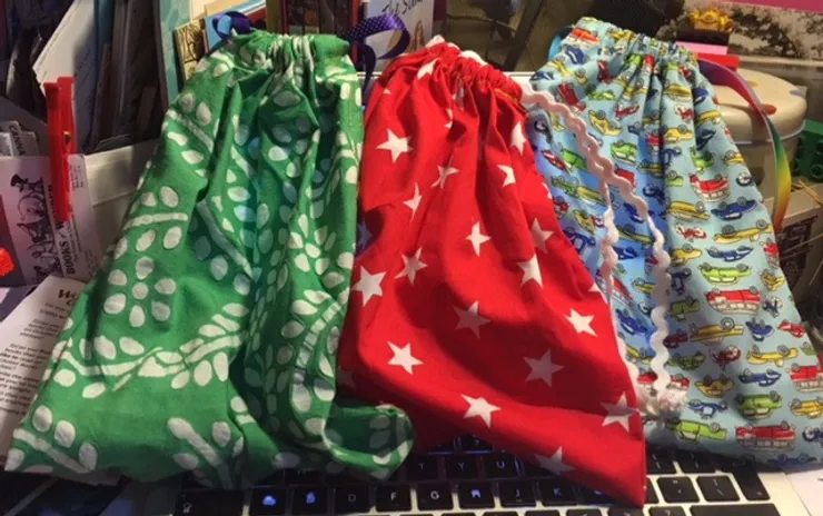3 cotton drawstring bags Jan used for helping children to ask questions.